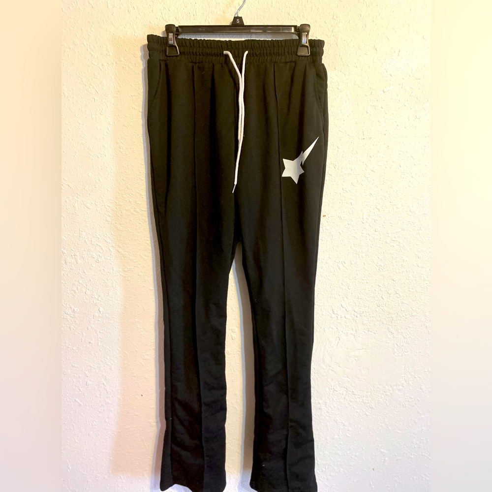 Black pants with shooting star logo on front and bottom flare legs